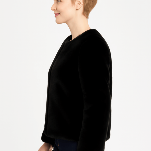 Model wearing a stylish black Faux Fur Trim Cape, showcasing its elegant silhouette and luxurious design.