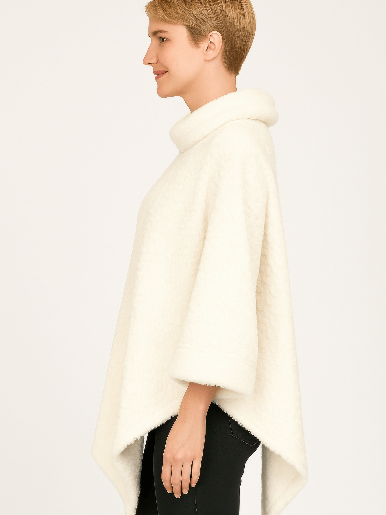 Textured Cowl Neck Poncho in ivory featuring a plush fabric and relaxed silhouette, showcasing a flattering pointed hemline.