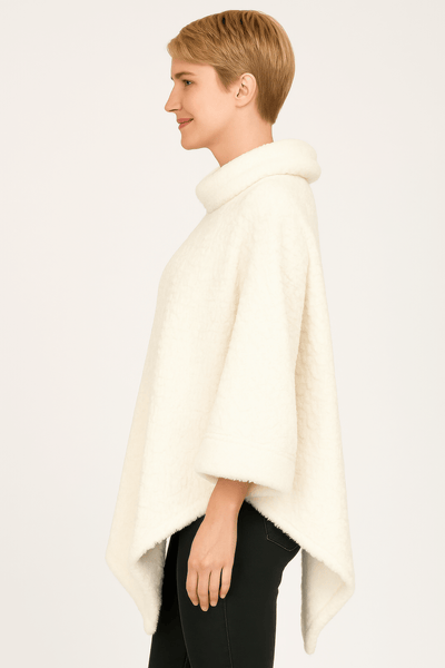 Textured Cowl Neck Poncho in ivory featuring a plush fabric and relaxed silhouette, showcasing a flattering pointed hemline.