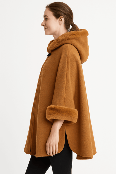 Side view of a model wearing a Hooded Faux Fur Trim Cape in warm brown, showcasing its elegant design and luxurious fur trim.