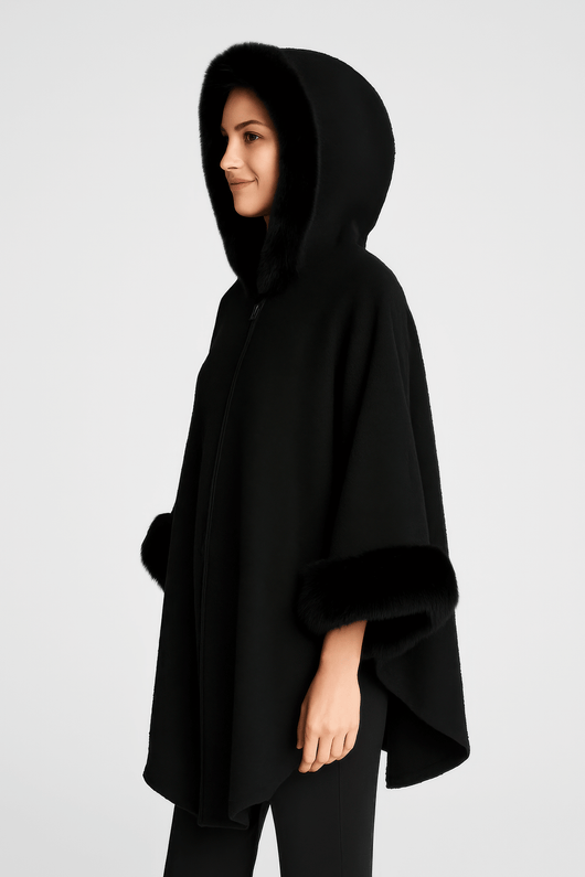 Hooded Faux Fur Trim Cape in black, featuring plush faux fur trim, a roomy hood, and wide sleeves for elegant warmth.
