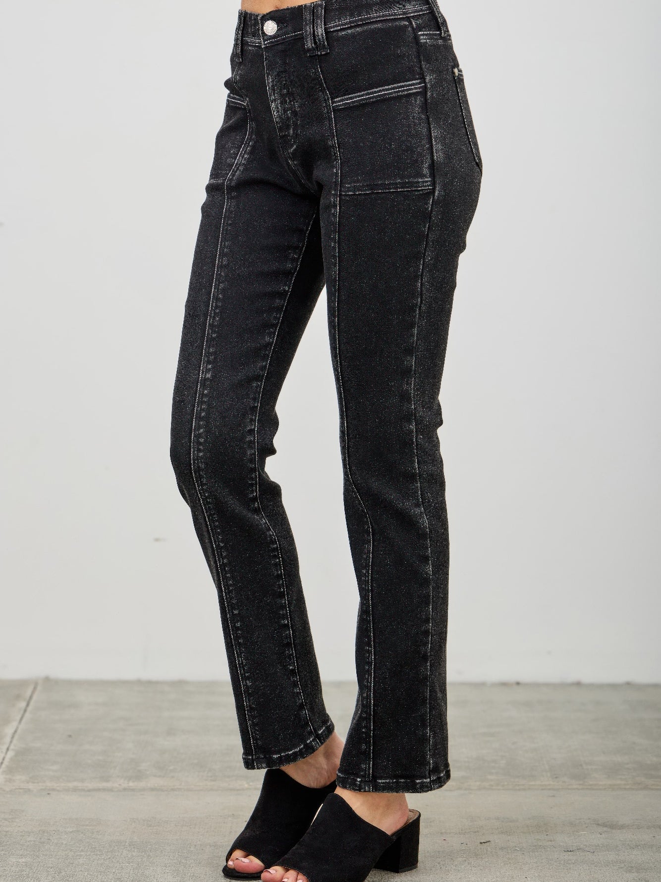 Mid Rise Slim Straight In Black Acid jeans featuring a flattering mid rise and slim straight leg, styled with open toe heels.