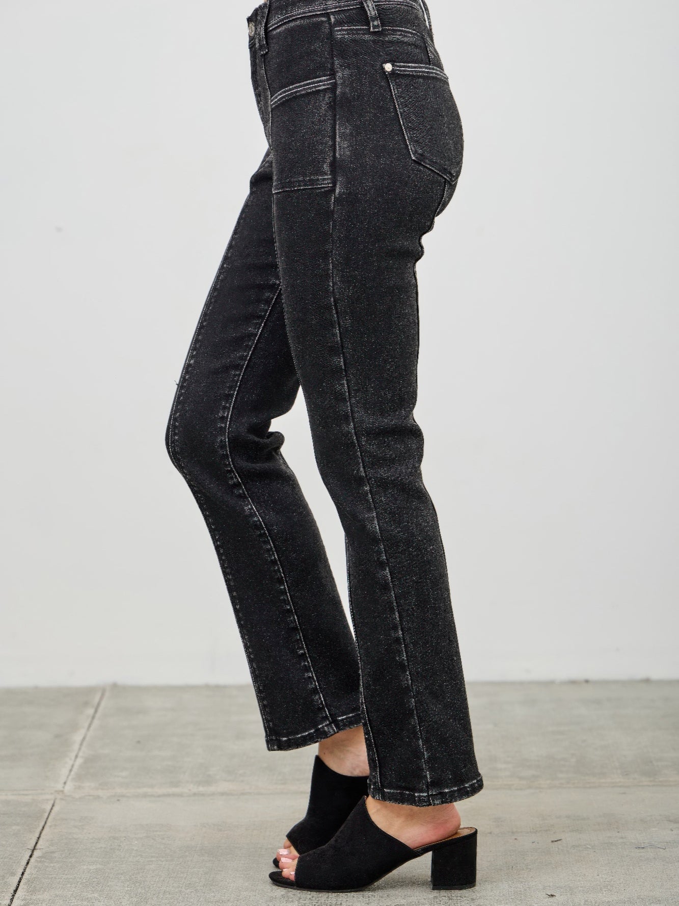 Mid Rise Slim Straight In Black Acid showcasing sleek black acid wash jeans with a slim straight leg and mid-rise fit.