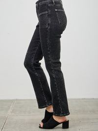 Mid Rise Slim Straight In Black Acid showcasing sleek black acid wash jeans with a slim straight leg and mid-rise fit.