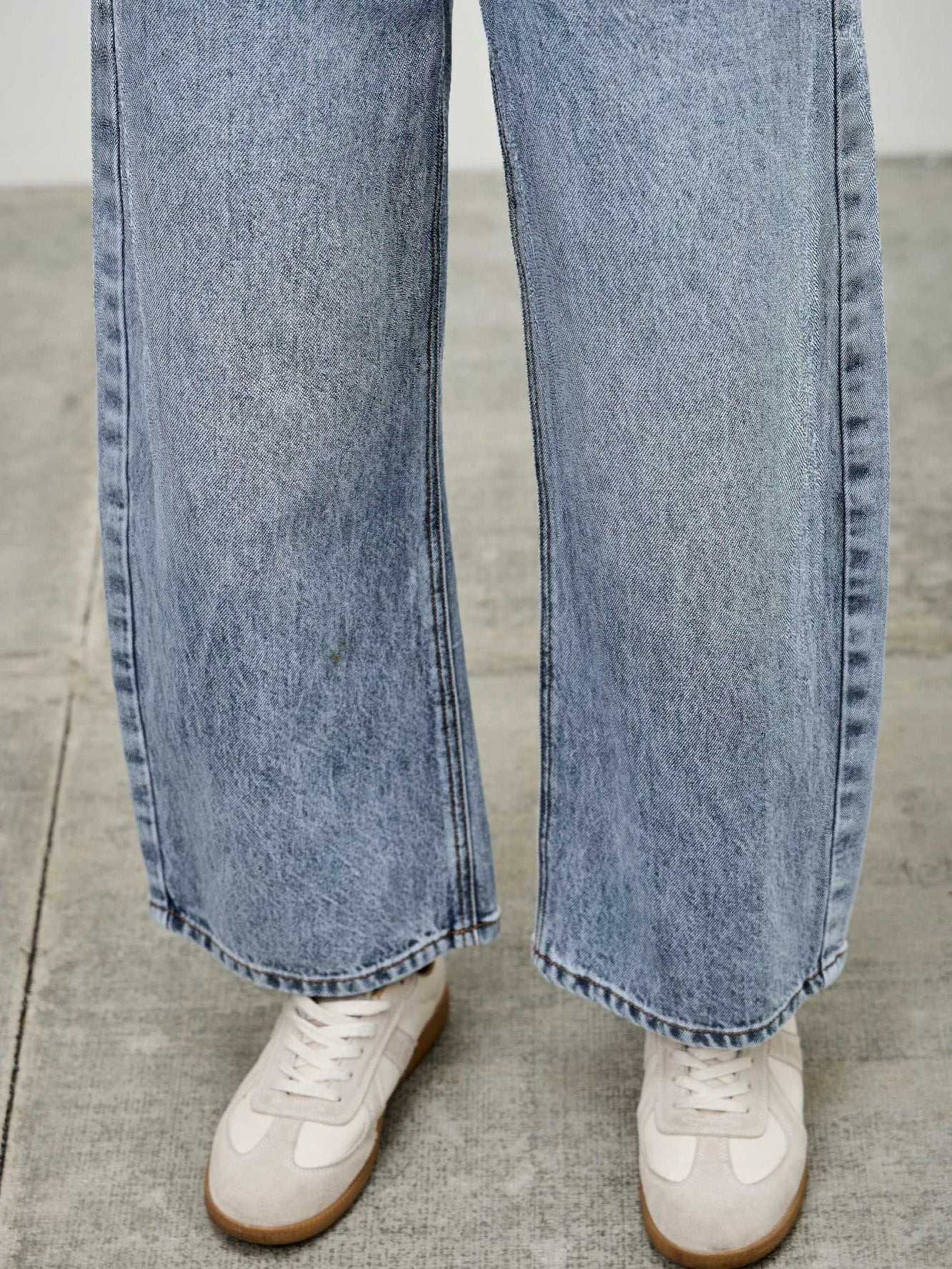 High Rise Low Curve Barrel jeans with a roomy barrel leg and stylish fit, paired with white sneakers.
