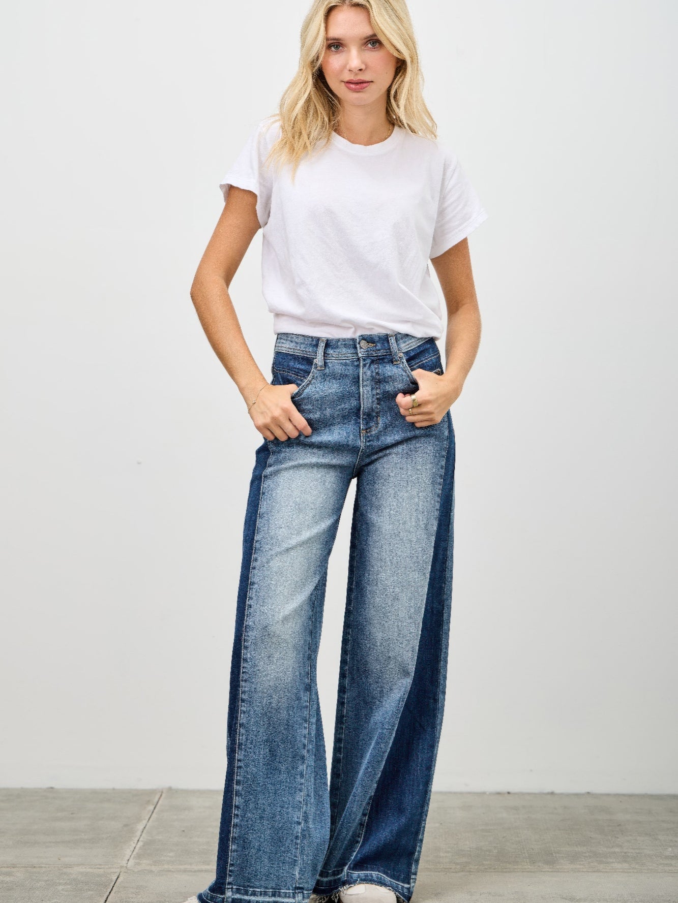 High Rise Wide Leg W/release Hem And Side Contrast showcased on model wearing a white t-shirt and stylish wide leg jeans.