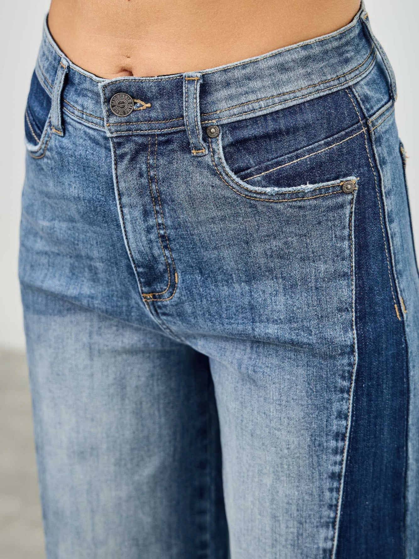 High Rise Wide Leg W/release Hem And Side Contrast showcasing the unique side paneling and raw hem detail.