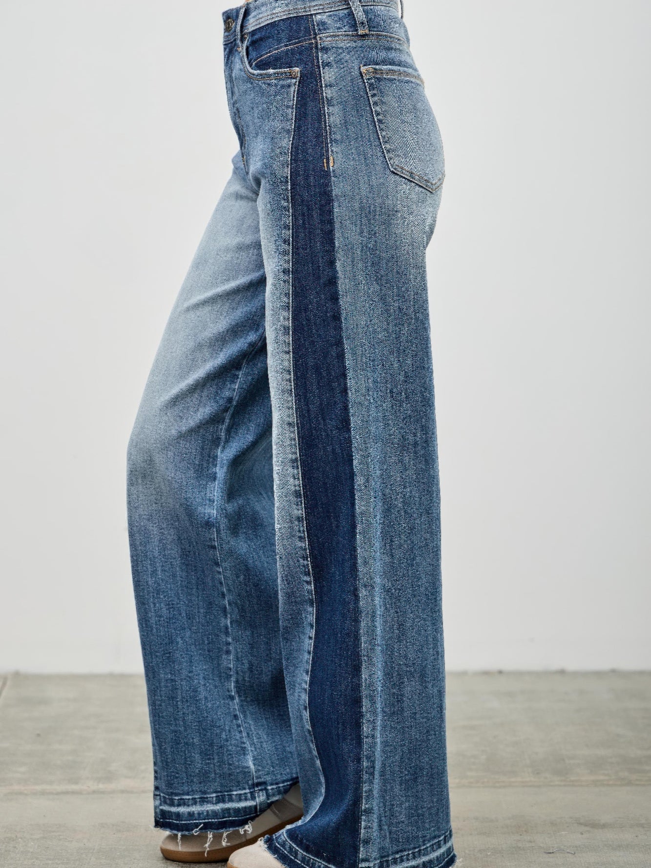 High Rise Wide Leg W/release Hem And Side Contrast showcasing a raw hem and side contrast paneling.