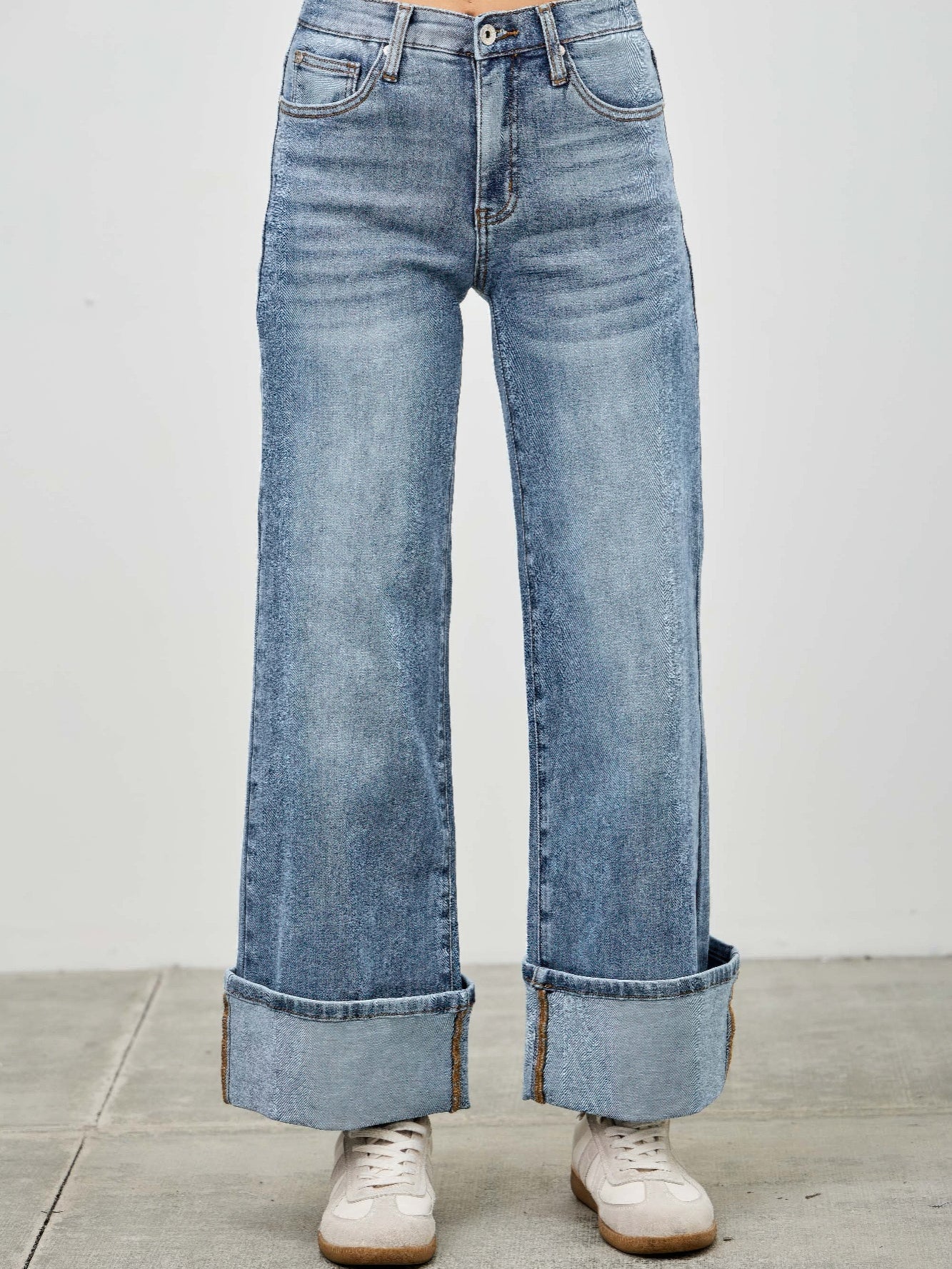 Mid Rise Cuffed Jeans With Stretch showcased on a model wearing stylish sneakers, highlighting the relaxed fit and cuffed hem.