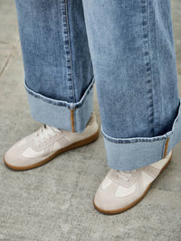 Mid Rise Cuffed Jeans With Stretch styled with white sneakers, showcasing a casual and polished look.