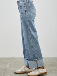 Mid Rise Cuffed Jeans With Stretch styled with casual sneakers, showcasing its versatile fit and cuffed hem.