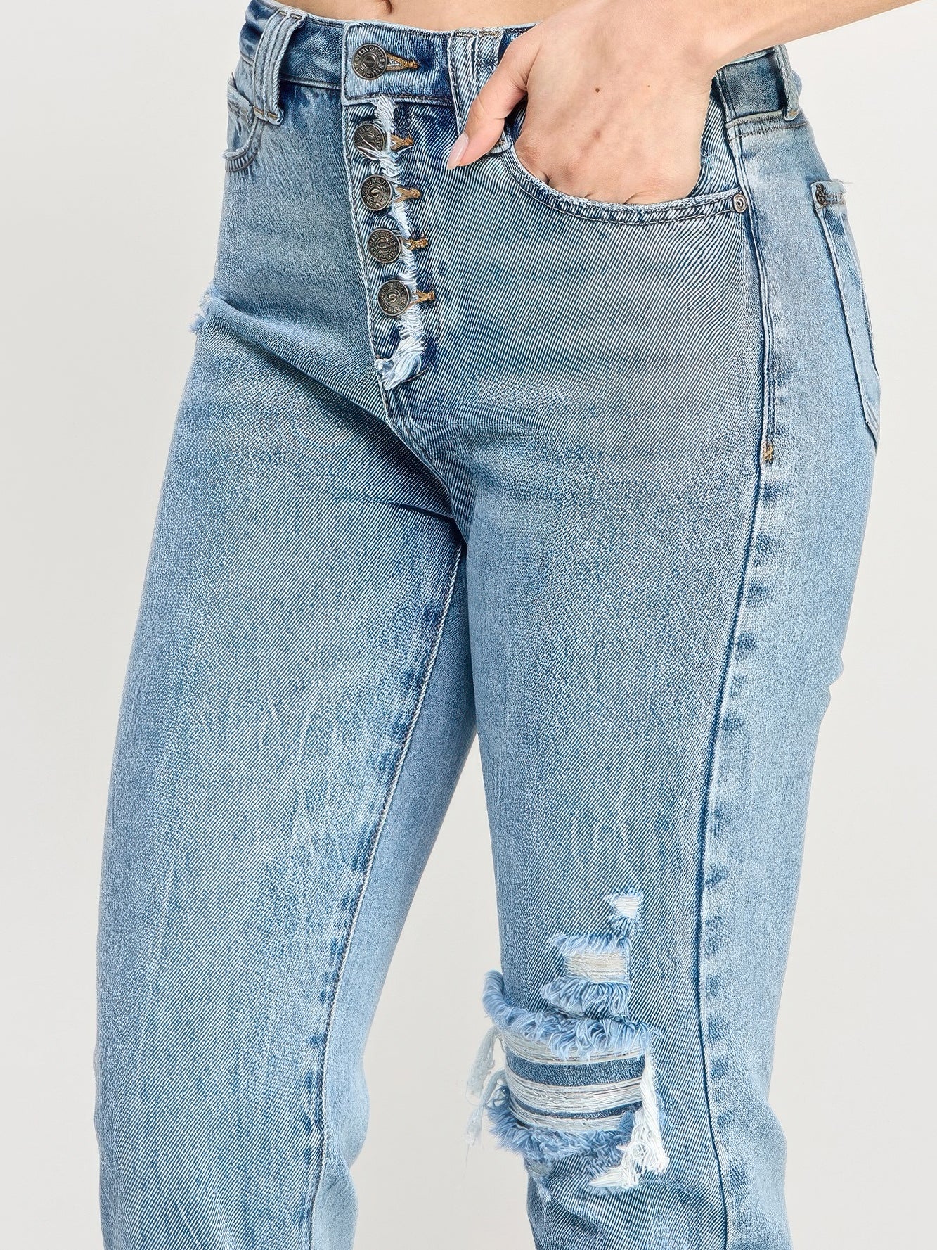 High Rise Button Fly Crop Slim Straight jeans showcasing a vintage button fly and distressed detailing.