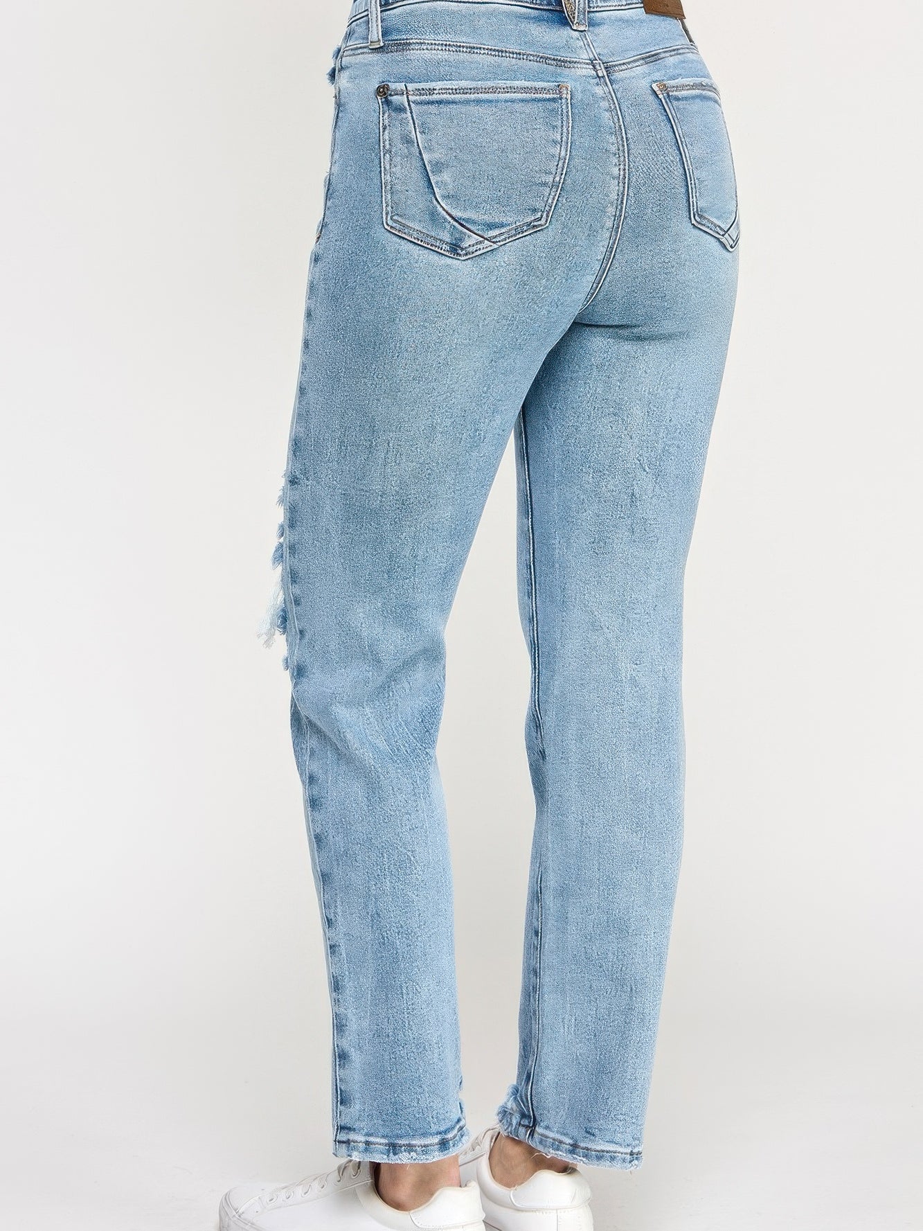 High Rise Button Fly Crop Slim Straight jeans showcasing back view with a slim straight leg in light wash denim.