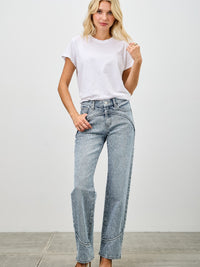 Model wearing Mid Rise Straight With Piping jeans styled with a white t-shirt and heels.