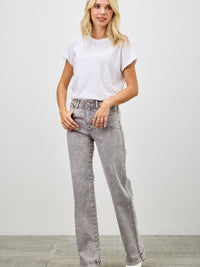 Model wearing High Rise Slim Wide Straight jeans with a white t-shirt and shoes, showcasing modern style.