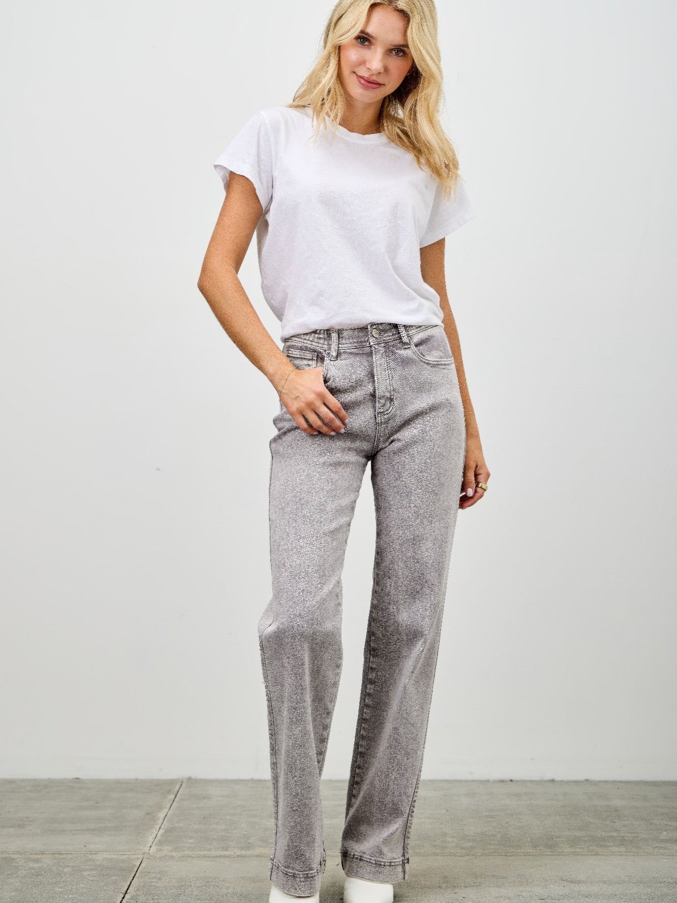 Model wearing High Rise Slim Wide Straight jeans paired with a white t-shirt in a casual setting.