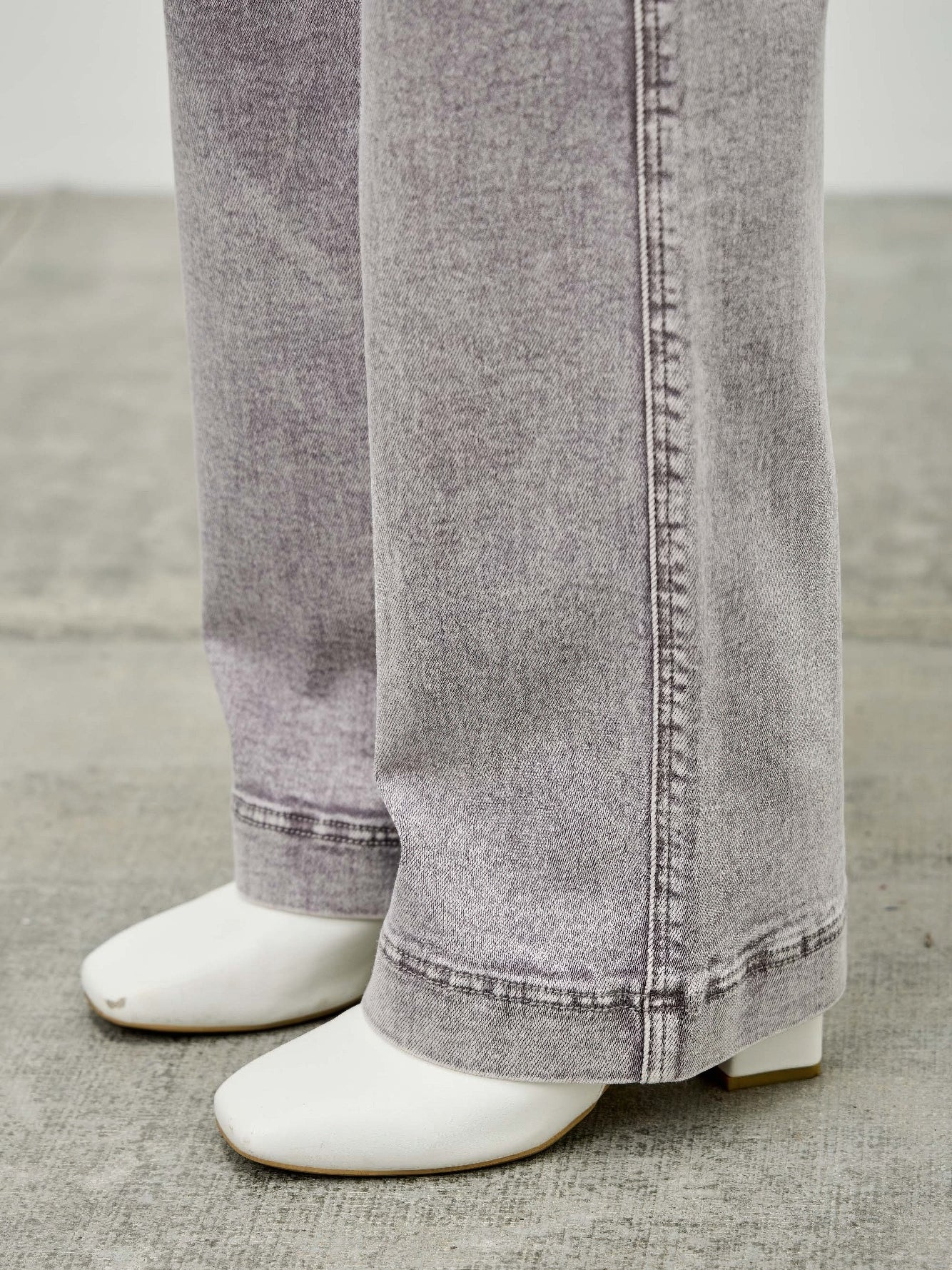 High Rise Slim Wide Straight jeans styled with trendy white heels, showcasing modern comfort and classic design.