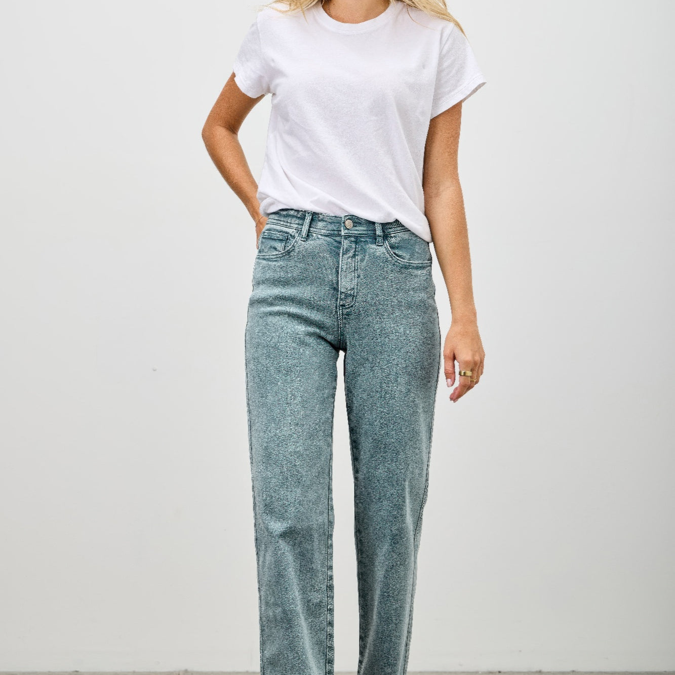 Model wearing High Rise Slim Wide Straight jeans with a white t-shirt, showcasing a modern silhouette and everyday comfort.
