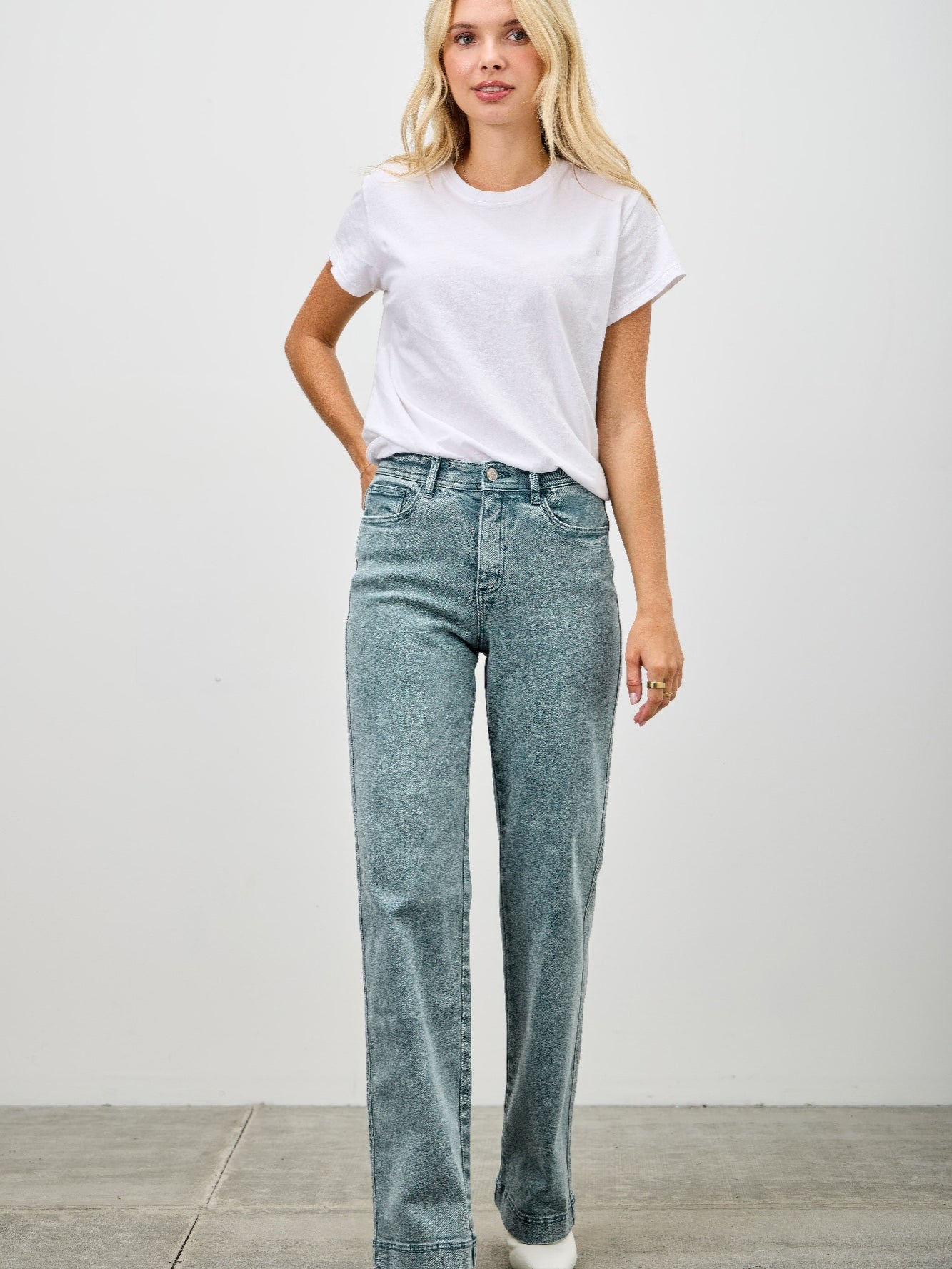 Model wearing High Rise Slim Wide Straight jeans with a white t-shirt, showcasing a modern silhouette and everyday comfort.