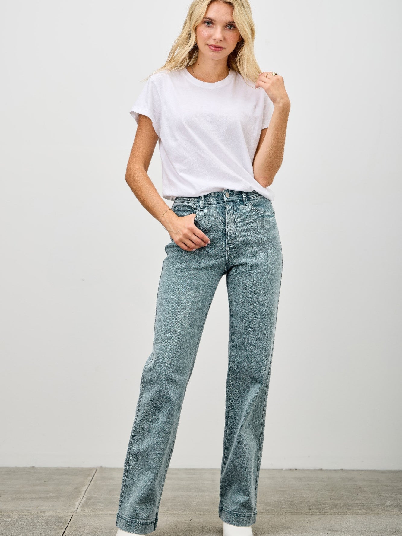 Model wearing High Rise Slim Wide Straight jeans with a white t-shirt and stylish ankle boots.