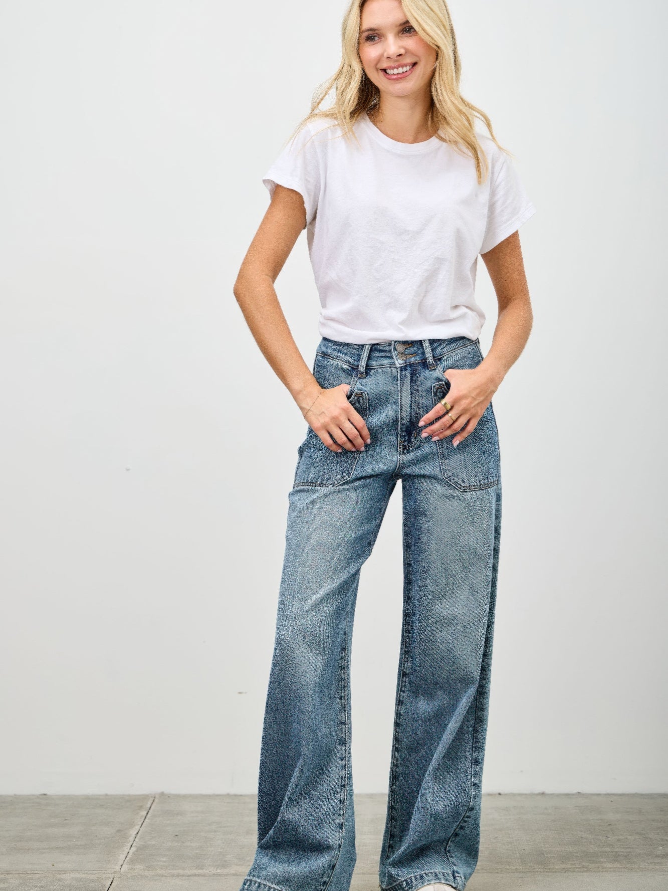 Model wearing High Rise Double Pocket Wide Leg jeans with a white t-shirt and relaxed fit pose.
