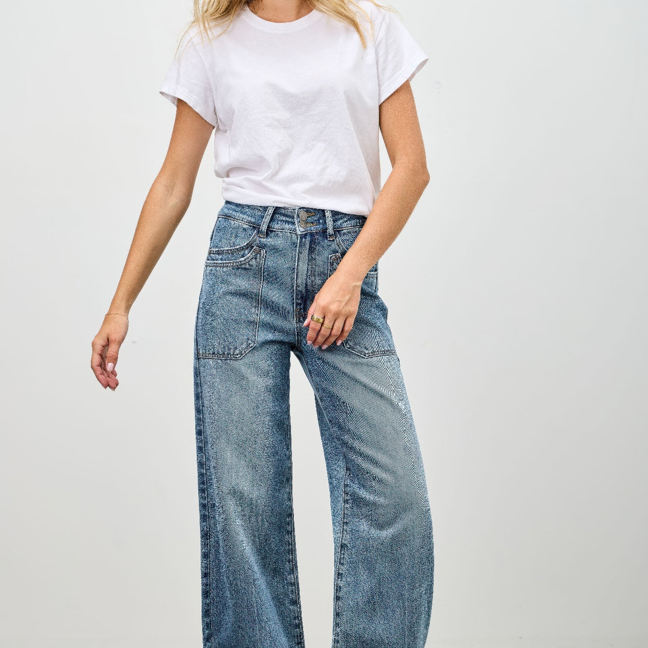Model wearing High Rise Double Pocket Wide Leg jeans with a white t-shirt and relaxed stance.