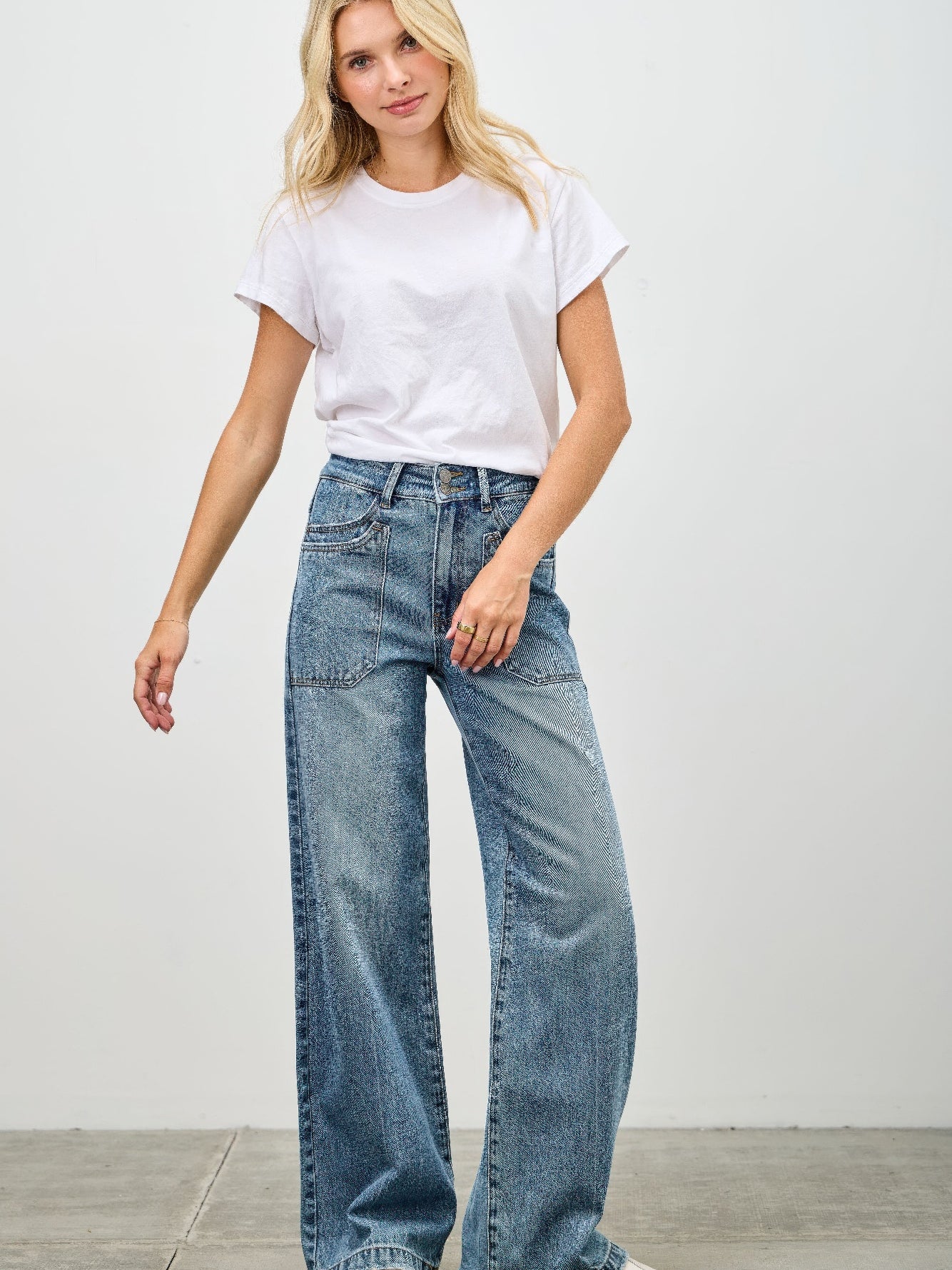 Model wearing High Rise Double Pocket Wide Leg jeans with a white t-shirt and relaxed stance.