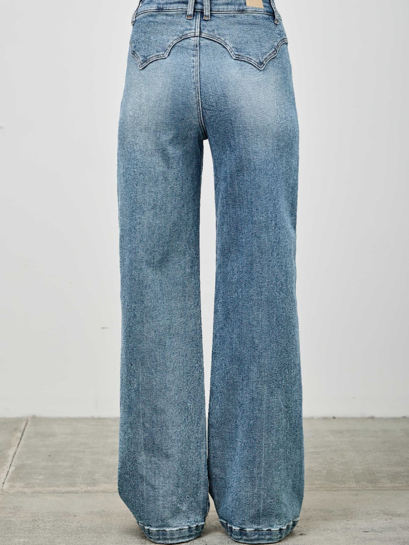 High Rise Double Pocket Wide Leg jeans showcasing a high-rise waist and wide leg silhouette from the back.