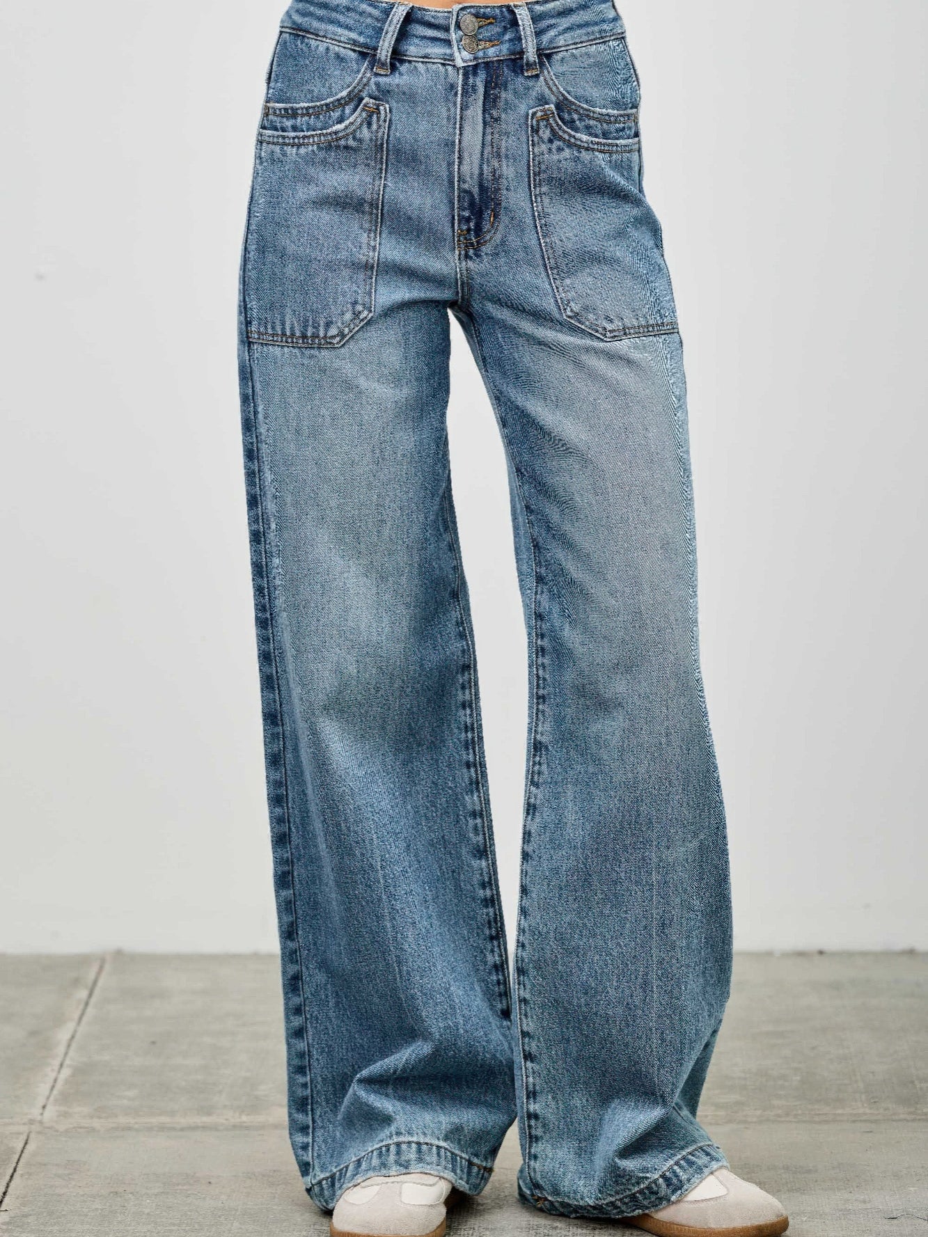 High Rise Double Pocket Wide Leg jeans featuring patched front pockets and a wide leg silhouette.