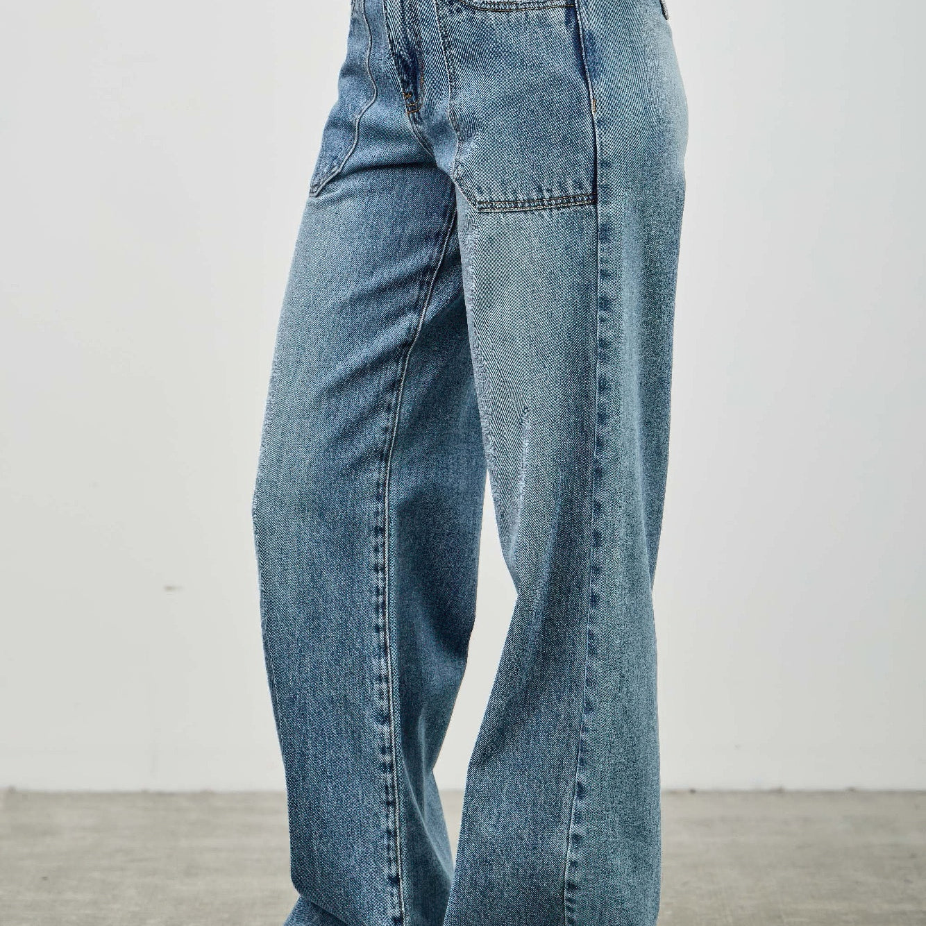 High Rise Double Pocket Wide Leg jeans featuring a wide leg silhouette and patched front pockets.