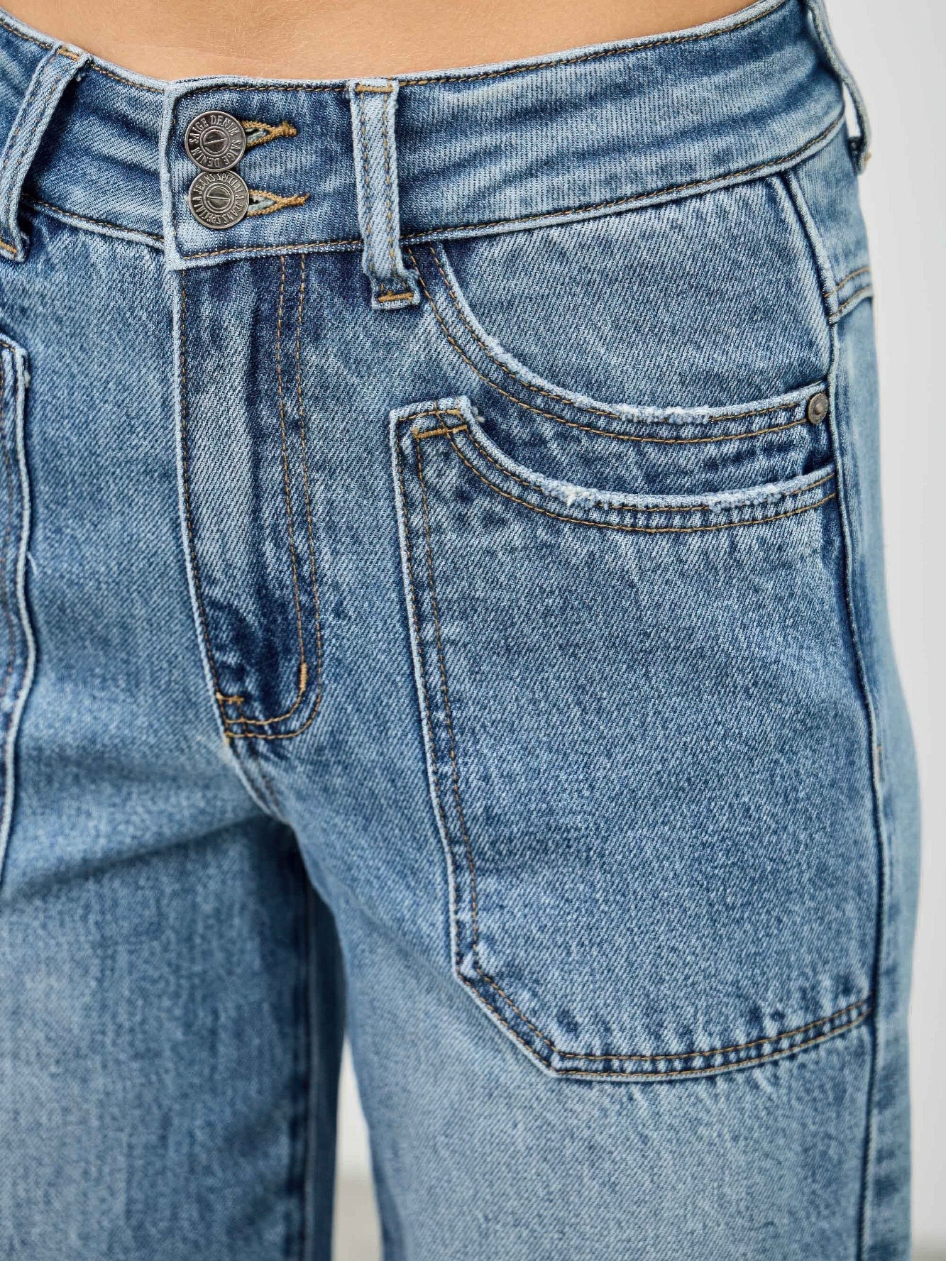 High Rise Double Pocket Wide Leg jeans featuring a high-rise waist, double front pockets, and a relaxed wide leg fit.