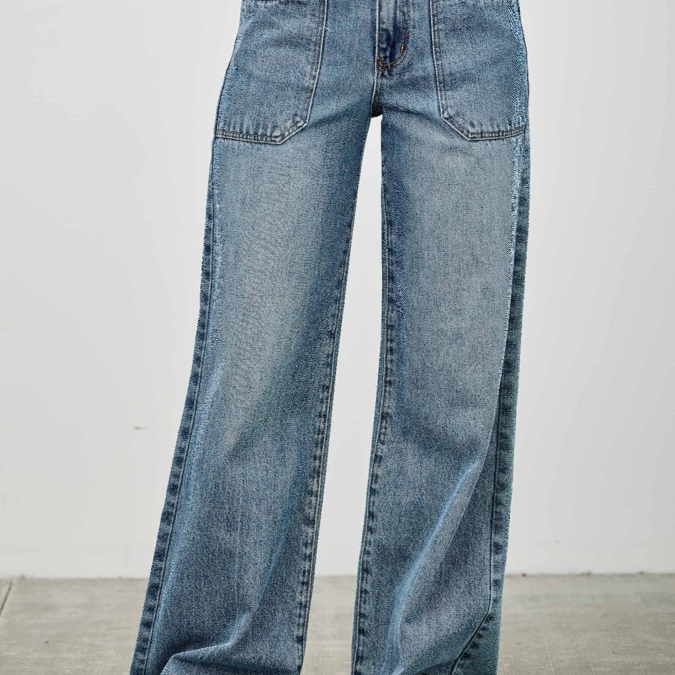 High Rise Double Pocket Wide Leg jeans with patched front pockets and a wide leg silhouette.