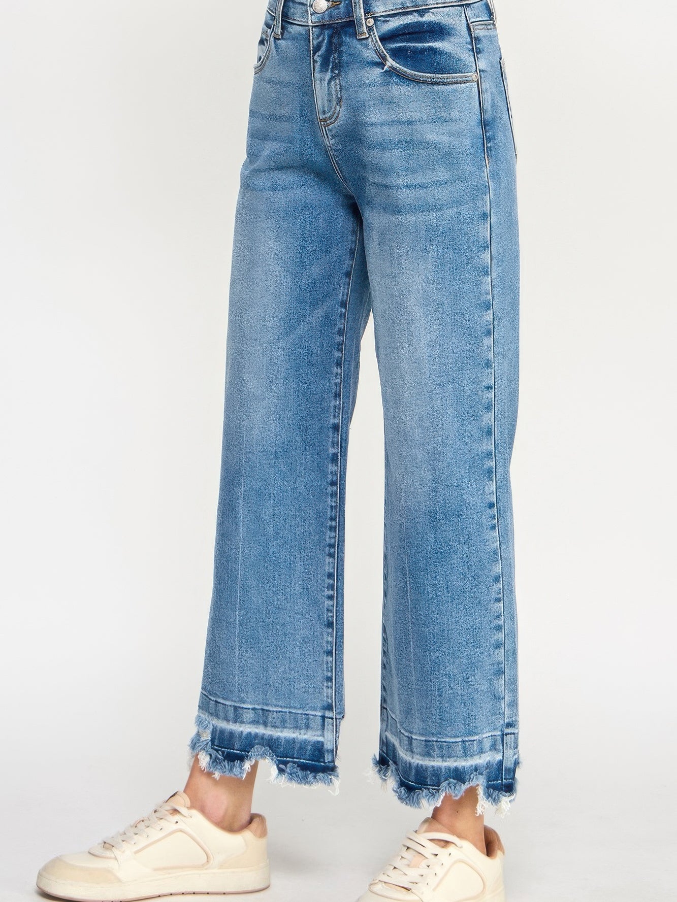 Tummy Control High Rise Crop Wide W/ Released Hem in light blue wash with frayed hem and relaxed fit.