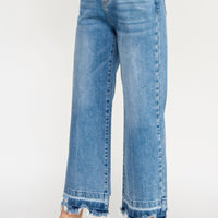 Tummy Control High Rise Crop Wide W/ Released Hem in light blue wash with frayed hem and relaxed fit.