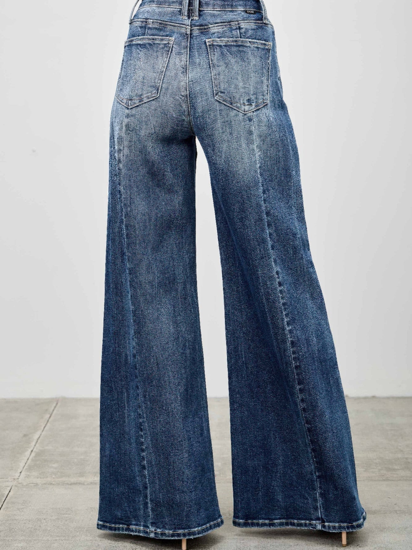 Back view of stylish Mid Rise Wid Leg jeans, featuring a wide leg silhouette and soft denim fabric.