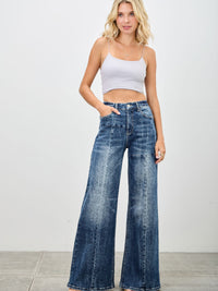 Model wearing Mid Rise Wid Leg jeans with a casual crop top, showcasing a relaxed yet chic outfit.
