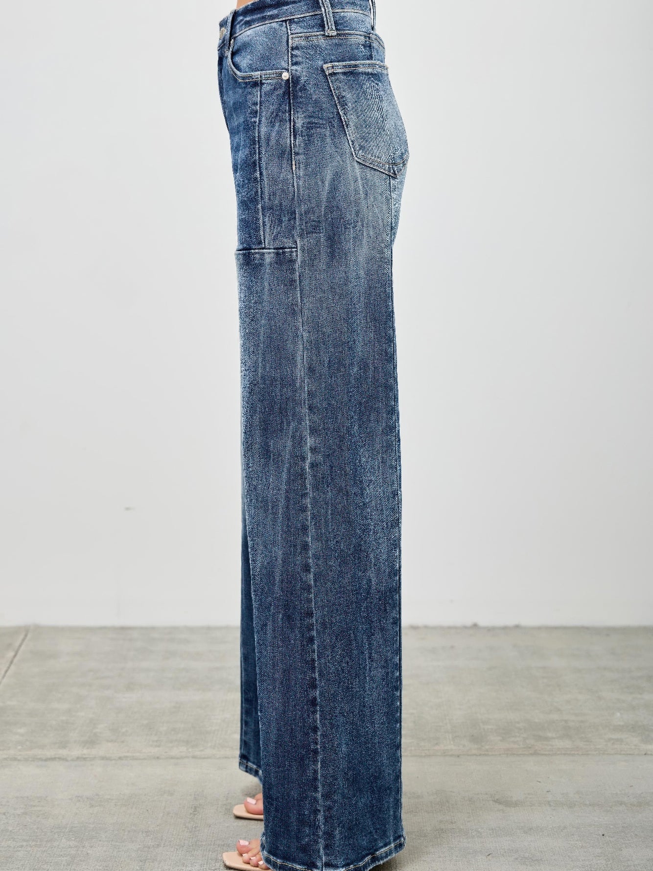 Side view of mid rise wide leg jeans showcasing their modern fit and stylish silhouette.