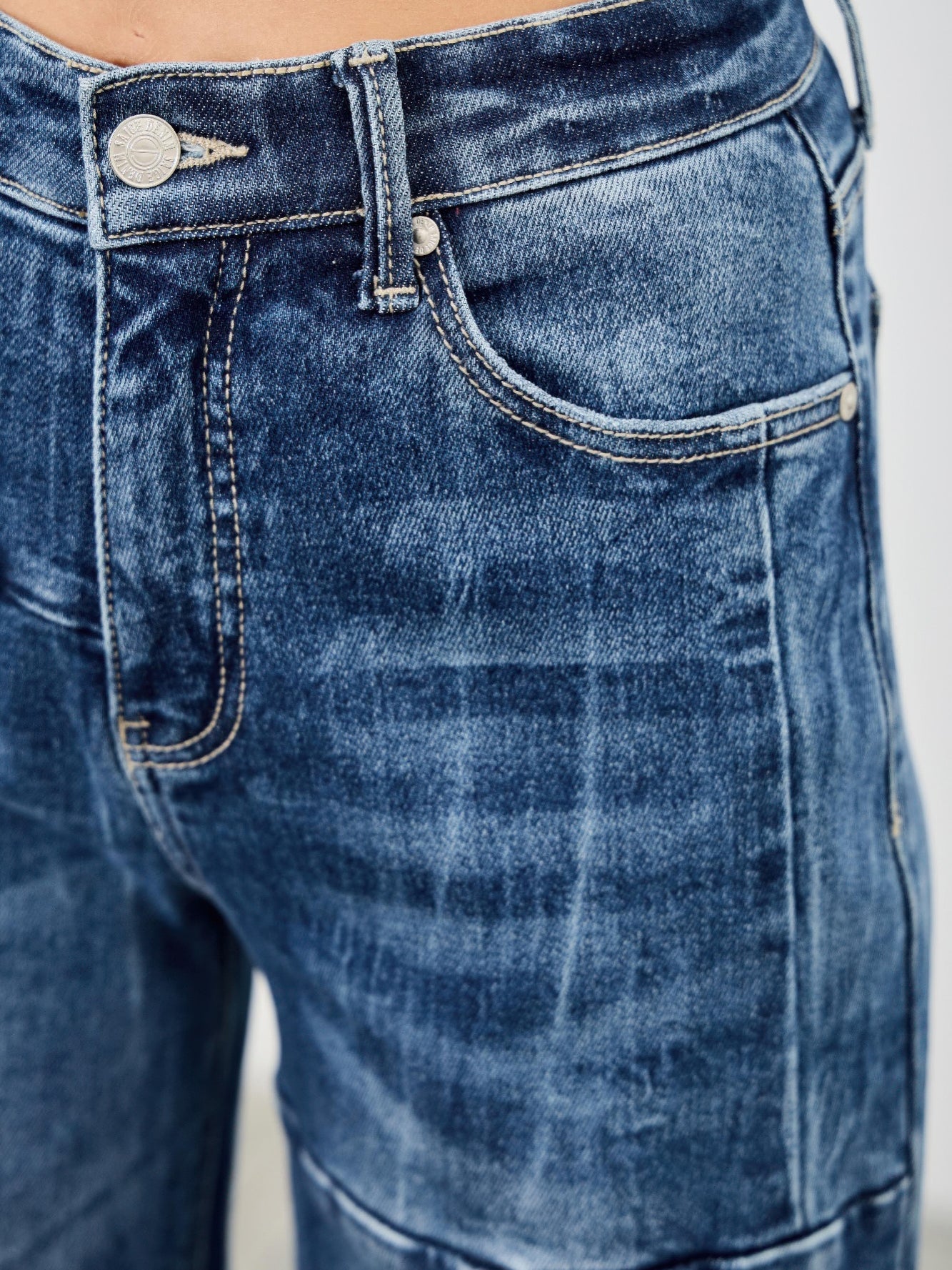 Close-up of mid rise wide leg jeans featuring a soft denim blend with a stylish fit.