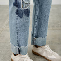High Rise Star & Heart Patched Dad Jean W/stretch featuring playful heart and star patches on a light blue denim.