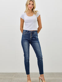 Model wearing High Rise Ankle Skinny With Button Fly denim, showcasing a stylish and modern fit.