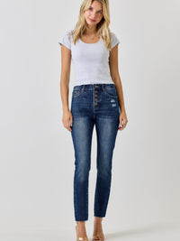 Model wearing High Rise Ankle Skinny With Button Fly jeans, featuring a fitted style and exposed button fly.