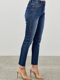 High Rise Ankle Skinny With Button Fly model showcasing form-fitting denim jeans in a stylish pose.