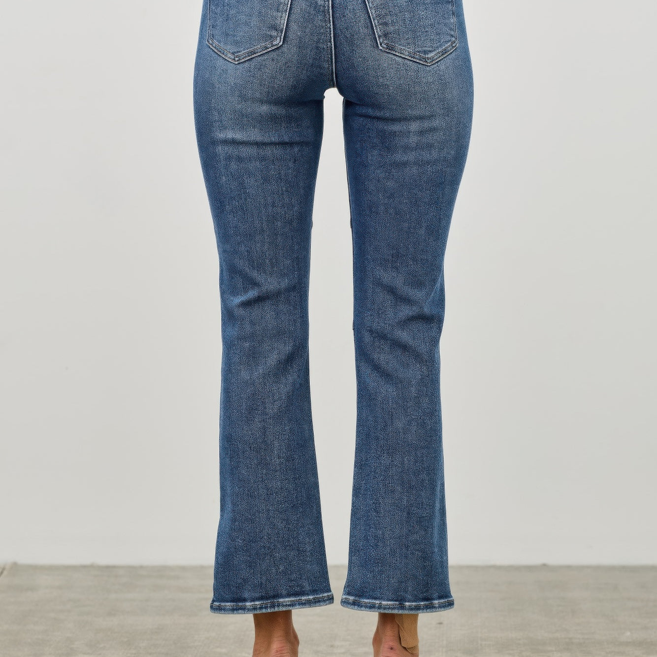 Back view of Mid Rise Skinny Crop Tummy Control jeans showcasing a flattering fit and stylish cropped length.
