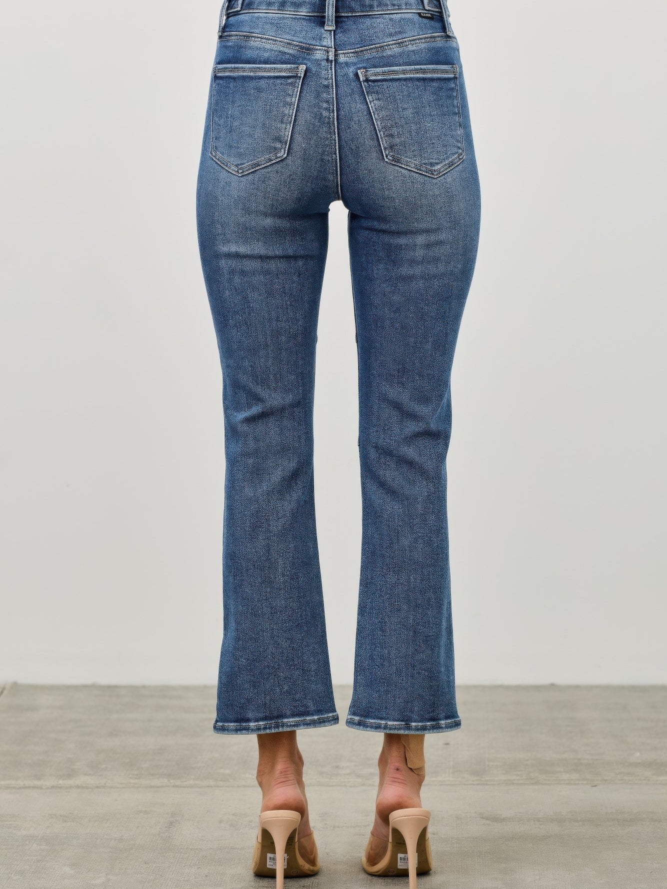 Back view of Mid Rise Skinny Crop Tummy Control jeans showcasing a flattering fit and stylish cropped length.