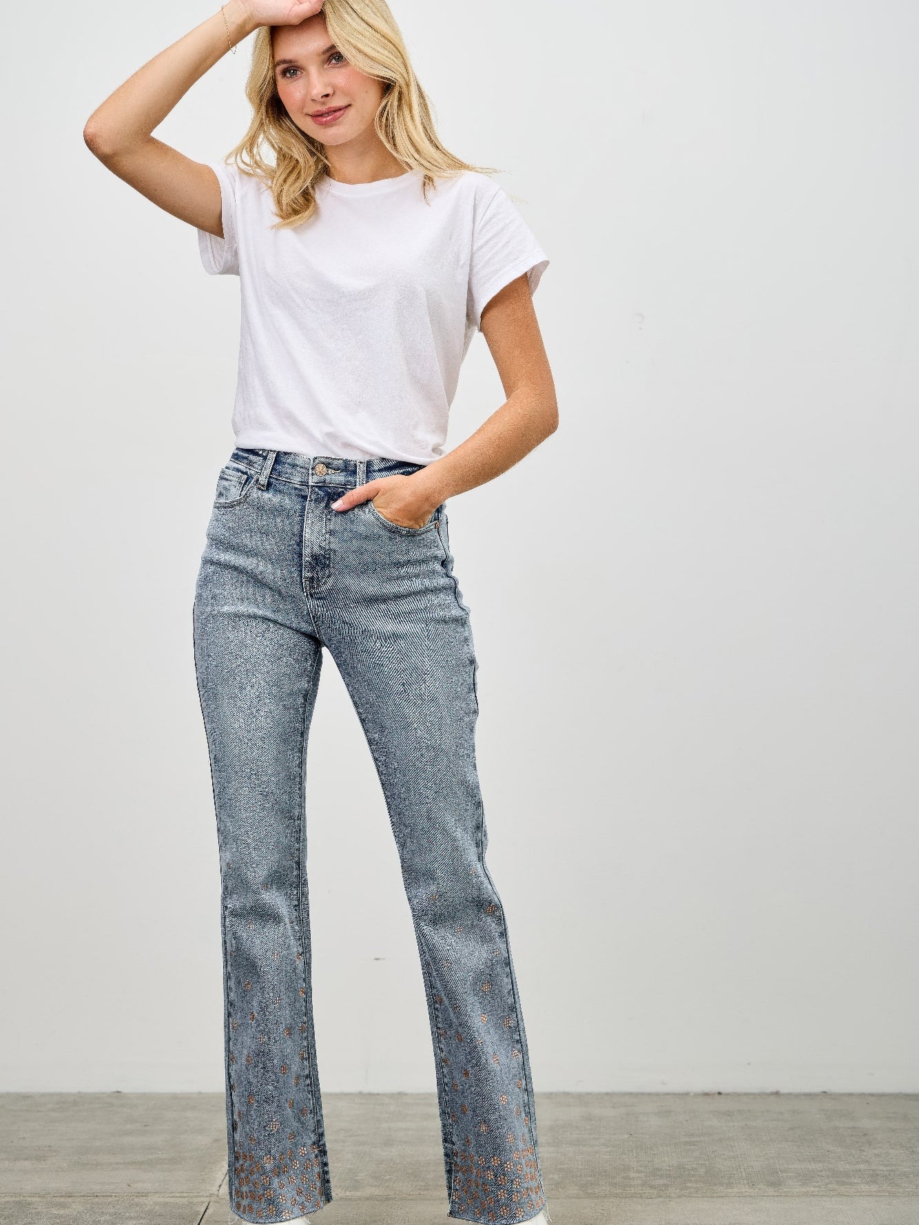 Model wearing High Rise Kick Flare With Rhinestone jeans, showcasing rhinestone embellishments and a stylish flare.