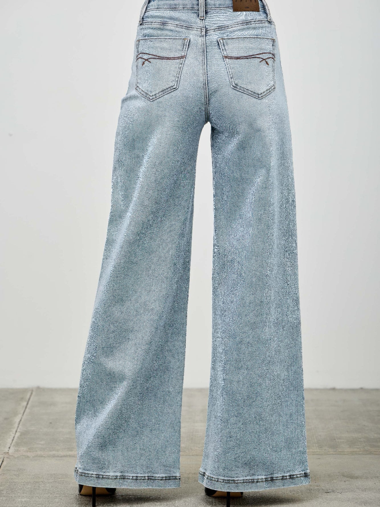 High Rise Wide Leg jeans featuring a flattering silhouette and comfortable fit, showcasing a back view.