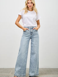 Model wearing High Rise Wide Leg jeans with a white t-shirt, showcasing a stylish denim look.