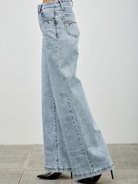 High Rise Wide Leg jeans shown in light wash, featuring a flattering wide leg design and high-waisted fit.