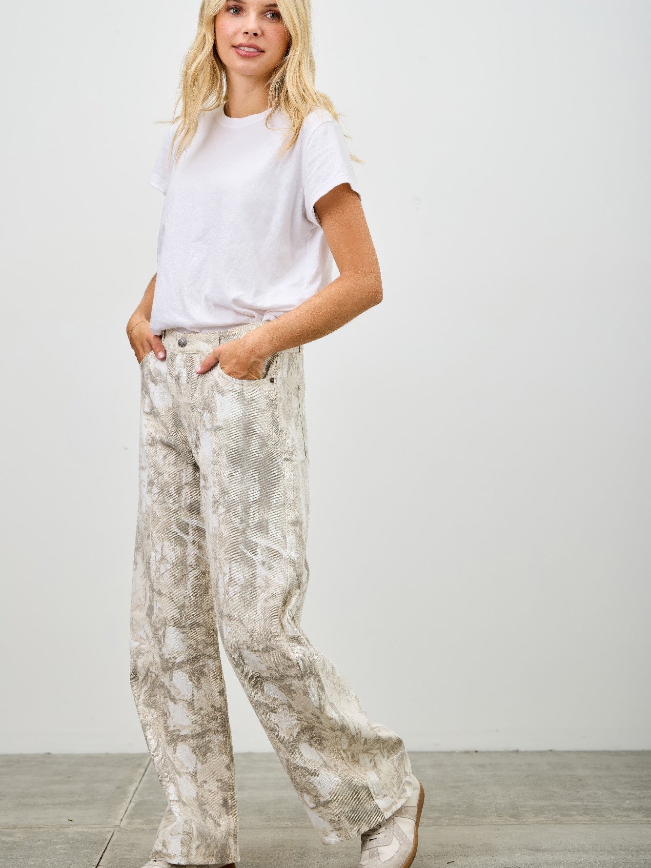High Rise Low Curve Barrel jeans in a stylish printed design, paired with a casual white t-shirt and comfortable shoes.
