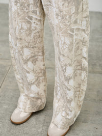 High Rise Low Curve Barrel jeans featuring a unique printed design and contemporary silhouette.